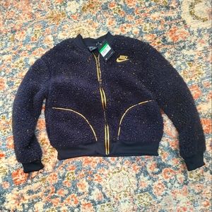 Girls Nike fleece jacket. Black and gold, XL